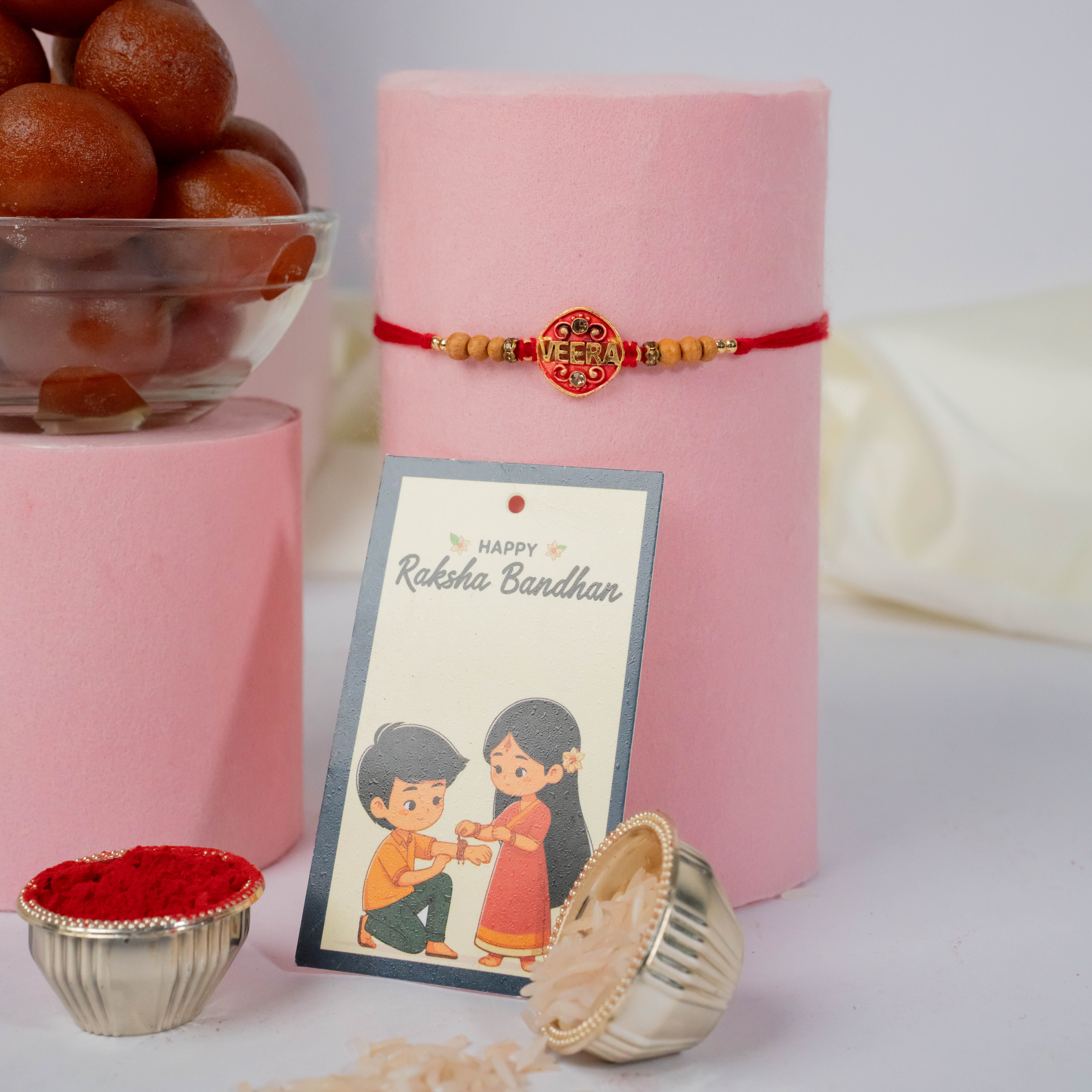 Stone Studded Metal Rakhi with Gulab Jamun