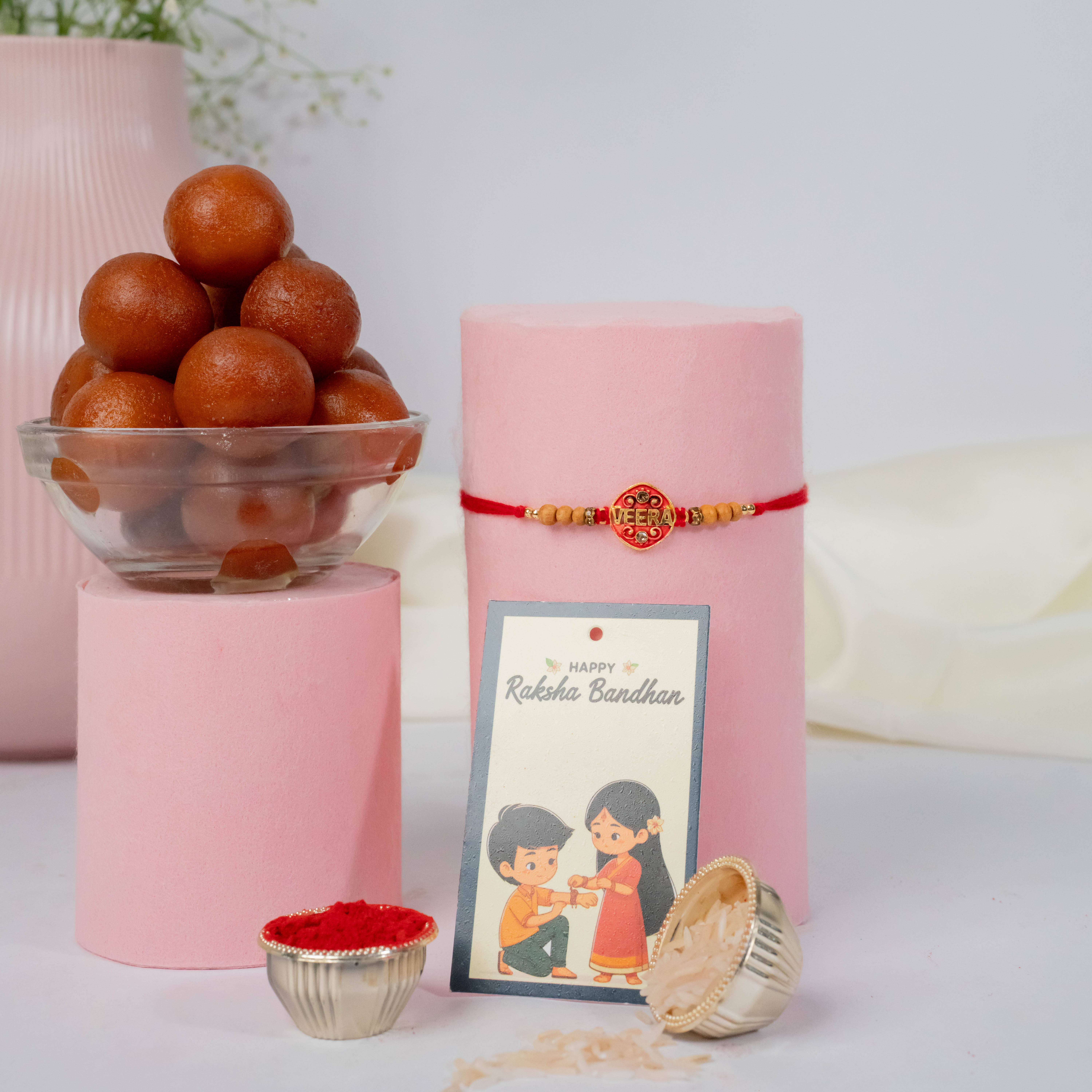 Stone Studded Metal Rakhi with Gulab Jamun